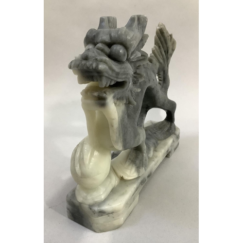 10 - A Chinese soapstone carving of a dragon with pearl, 20.5cm long x 18cm high
