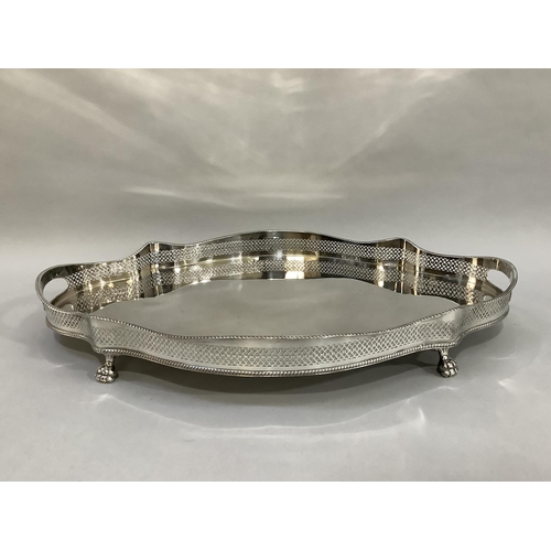 4 - A large silver plated two-handled galleried tray of oval serpentine outline with gadroon rims and pa... 