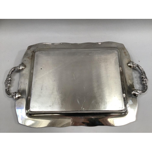 6B - A heavy plated on copper two-handled tray with foliate handles and rim, rectangular, presentation in... 