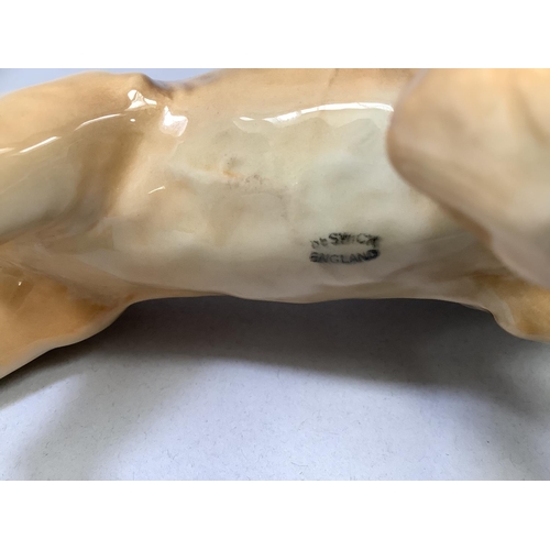36 - A Beswick model of a lion, approximately 22cm long