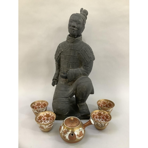12 - A black ceramic copy of a Chinese terracotta warrior kneeling, 40cm high, (constructed in two pieces... 