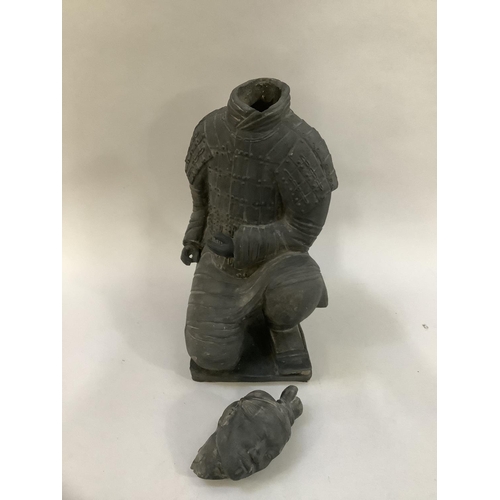 12 - A black ceramic copy of a Chinese terracotta warrior kneeling, 40cm high, (constructed in two pieces... 