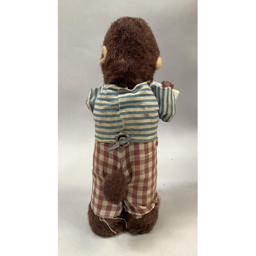 10 - An Alps Japan clockwork Thirsty Monkey, pouring milk from a bottle to a glass and drinking, 17cm hig... 