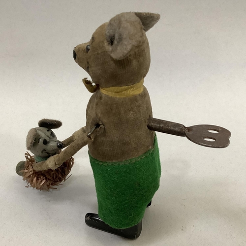 8B - A German Schuco clockwork group of two dancing mice, with key, together with a German tin plate cloc... 