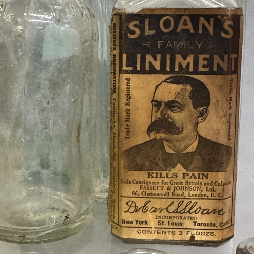 202 - A collection of 25 late 19th and early 20th century bottles, including Sloan’s Family Liniment, Owbr... 