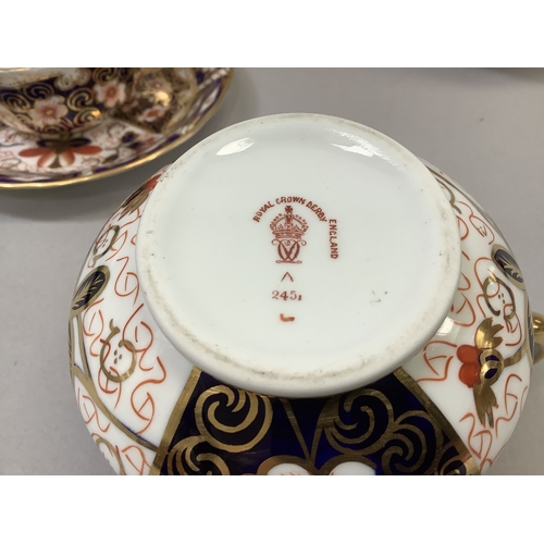 312 - A Royal Crown Derby trio of cup, saucer and tea plate, pattern no. 2451, date cypher for 1904 togeth... 