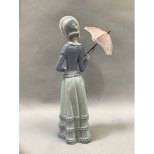 320 - A Lladro figure of girl with parasol measuring 31.5cm high