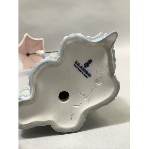 320 - A Lladro figure of girl with parasol measuring 31.5cm high