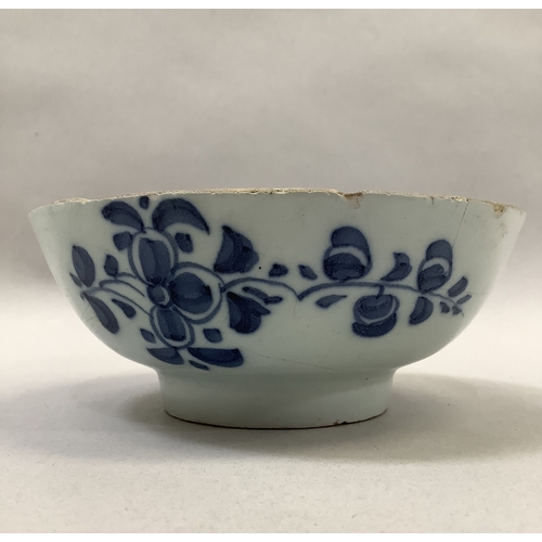 322 - A tin glaze bowl painted with flowers to the exterior and well on deep foot rim, measuring 12.75cm d... 