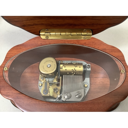 332 - A swiss musical box by Reuge of quatrefoil form inlaid to the lid with musical instruments, the Swis... 