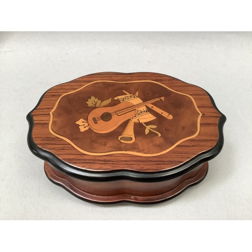 332 - A swiss musical box by Reuge of quatrefoil form inlaid to the lid with musical instruments, the Swis... 