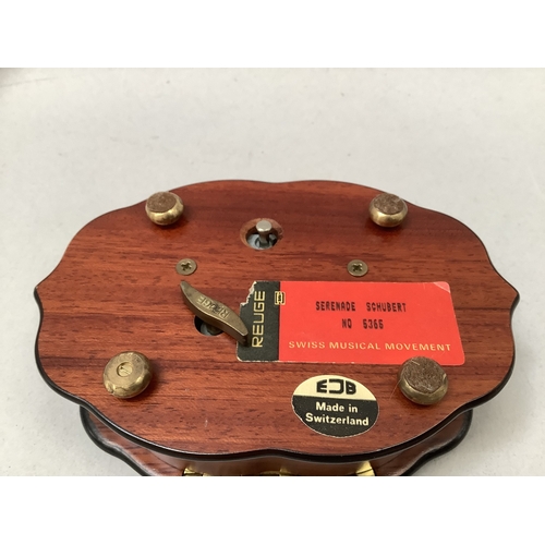 332 - A swiss musical box by Reuge of quatrefoil form inlaid to the lid with musical instruments, the Swis... 