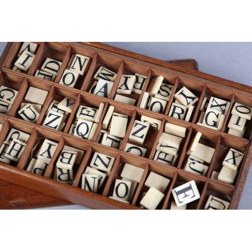 42 - A VICTORIAN SET OF BONE ALPHABET SPELLING TILES, contained in a divided tray-box with sliding lid, a... 
