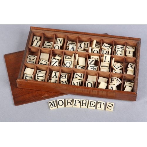 42 - A VICTORIAN SET OF BONE ALPHABET SPELLING TILES, contained in a divided tray-box with sliding lid, a... 