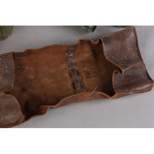 18 - A 19TH CENTURY GREEN LEATHER COVERED TRAVEL WRITING CASE of tube form, containing a leather quill wr... 