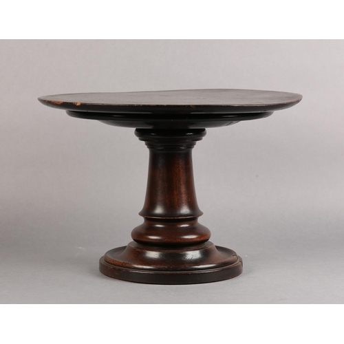 19 - A 19TH CENTURY MAHOGANY STAND, the circular top with screw thread on a turned column and dished base... 