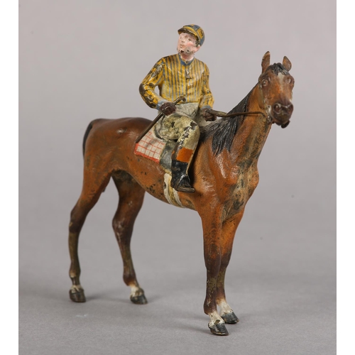 60 - AN EARLY 20TH CENTURY COLD PAINTED BRONZE MODEL OF A RACE HORSE with jockey up, 11cm high
