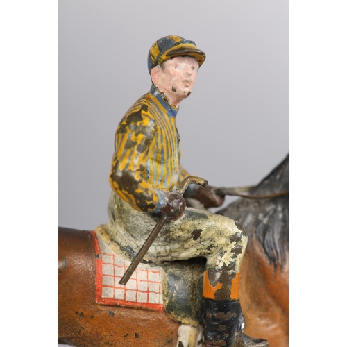 60 - AN EARLY 20TH CENTURY COLD PAINTED BRONZE MODEL OF A RACE HORSE with jockey up, 11cm high