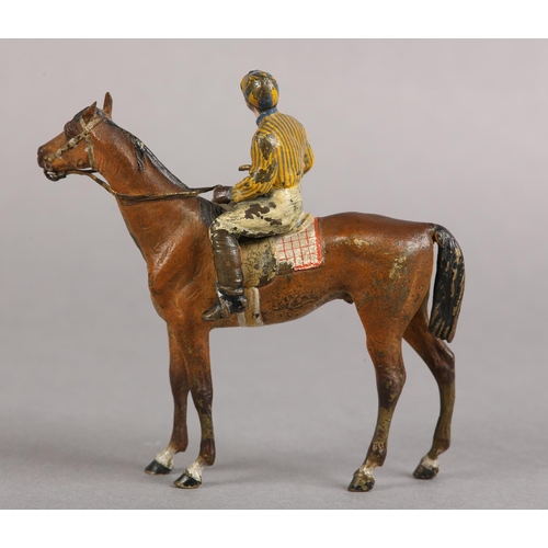 60 - AN EARLY 20TH CENTURY COLD PAINTED BRONZE MODEL OF A RACE HORSE with jockey up, 11cm high
