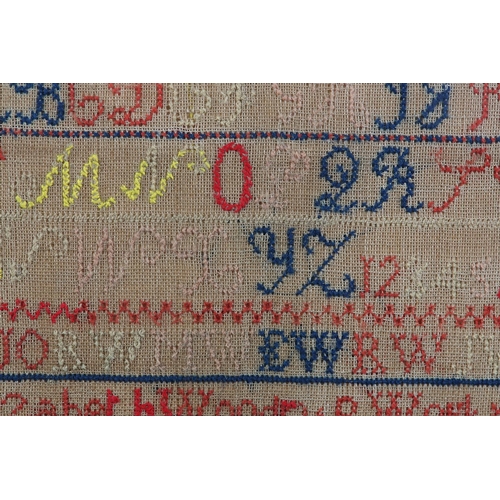 12 - A MID 19TH CENTURY SAMPLER by Elizabeth Woodrup Aged 12 Years March 22 1854, with alphabet and numbe... 