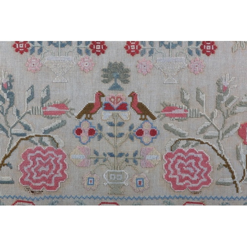 13 - A MID 19TH CENTURY SAMPLER by Elizabeth Woodrup Aged 13 1855, worked in coloured wools on linen with... 