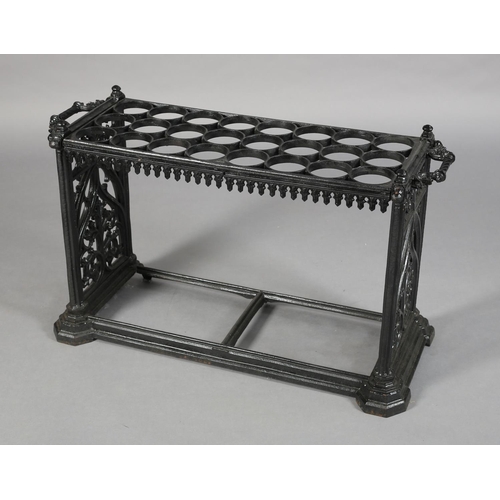 27 - A MID VICTORIAN CAST IRON STICK STAND, having eight rows of three circular rings, above a pendant ap... 