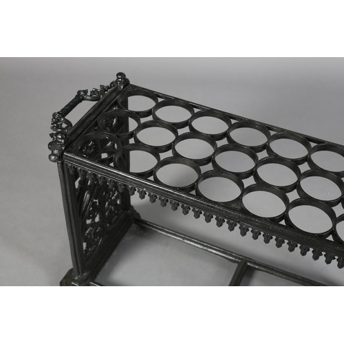 27 - A MID VICTORIAN CAST IRON STICK STAND, having eight rows of three circular rings, above a pendant ap... 