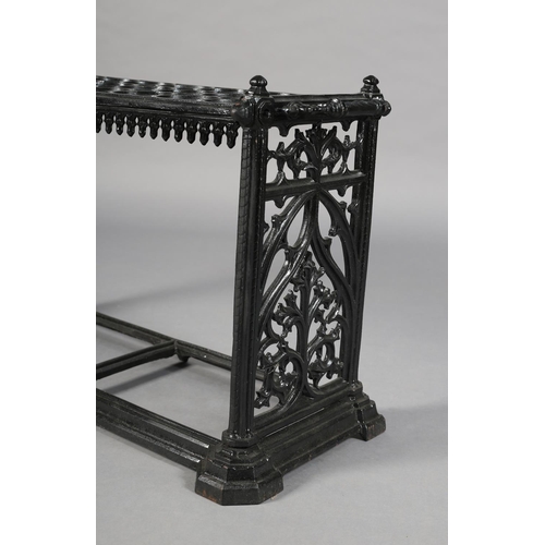 27 - A MID VICTORIAN CAST IRON STICK STAND, having eight rows of three circular rings, above a pendant ap... 