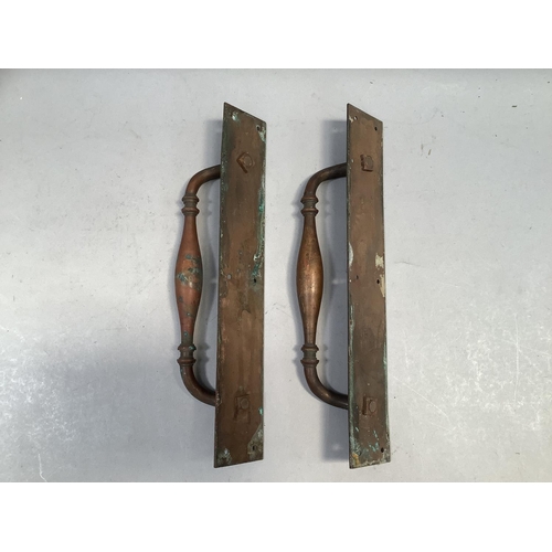 46 - A pair of copper door handles by Leggott's no. 2807, 35.5cm high x 6cm wide to the door plate