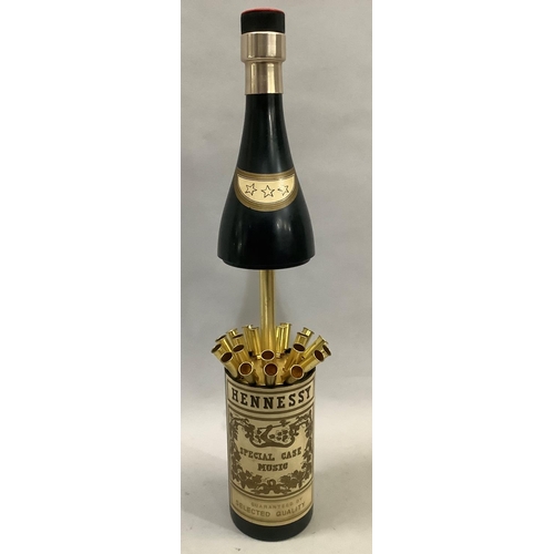 35 - A musical Hennessy bottle cigarette dispenser, 32cm closed, 42cm open