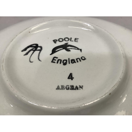 28 - A Poole Pottery Aegean dished plate of maple leaf design in brown on a dark brown ground, 26.5cm dia... 