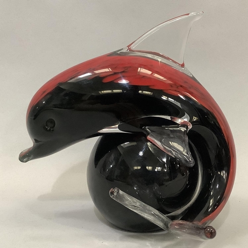 29 - V & C Nason for Murano, Italy, a dolphin and ball, red and black cased in clear glass, label to unde... 