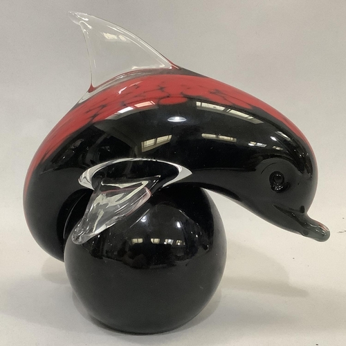 29 - V & C Nason for Murano, Italy, a dolphin and ball, red and black cased in clear glass, label to unde... 