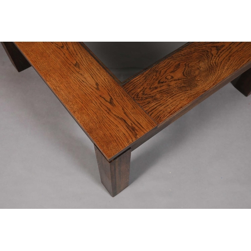 47 - A brutalist oak and glass inset coffee table, on square legs, 100cm square x 45cm high