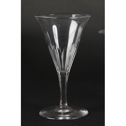 53 - A set of sixteen crystal glass champagne flutes, the drawn conical bowl slice cut, on six-sided stem... 