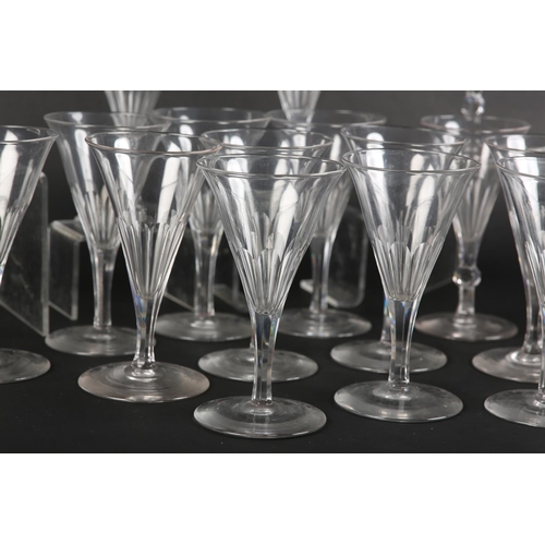 53 - A set of sixteen crystal glass champagne flutes, the drawn conical bowl slice cut, on six-sided stem... 