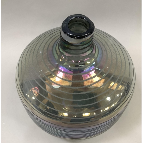 13 - A large heavy iridescent glass vase with bottle neck and incised trailed decoration, 22cm high