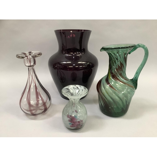 15 - Four items of art glass including a green glass jug of writhen moulding streaked with yellow, burgun... 