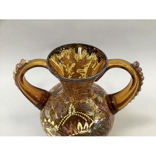 17 - A hand painted Spanish two handled vase in amber glass 18.5cm high