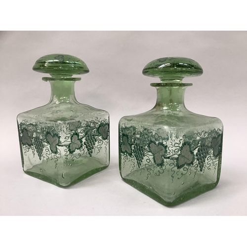 22 - A pair of green soda glass decanters of square outline with mushroom stoppers painted with fruiting ... 
