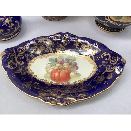 23 - A Crescent china two handled vase painted with reserves of flowers against a dark blue and gilt grou... 