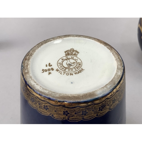 23 - A Crescent china two handled vase painted with reserves of flowers against a dark blue and gilt grou... 