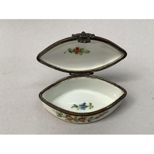 24 - A shell shaped dish painted in polychrome enamels with flowers with gilt rim lines, blue crossed swo... 