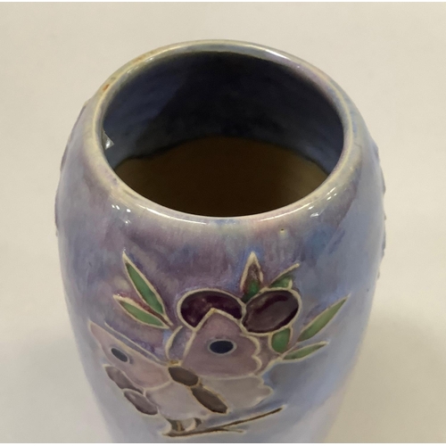 29 - A Royal Doulton stone ware vase of streaked mauve glaze tube lined with a butterfly on a fruiting br... 