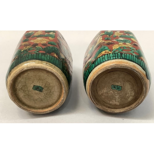 32 - A pair of Japanese pottery vases of hexagonal outline, the buff ground painted with multiple figures... 