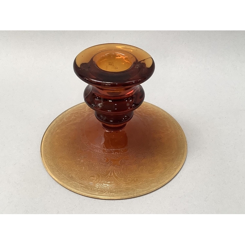 36 - A set of five amber glass candlesticks on circular domed bases, etched with a scrolled border 12.5cm... 