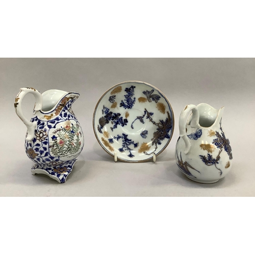 45 - A Japanese porcelain milk jug, with blue foliate transfer design and profusely painted with flowers ... 