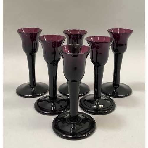 35 - A set of six amethyst glass liqueurs, 11.5cm, having a bell shaped bowl and on folded foot