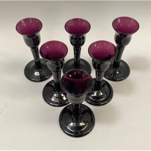 35 - A set of six amethyst glass liqueurs, 11.5cm, having a bell shaped bowl and on folded foot