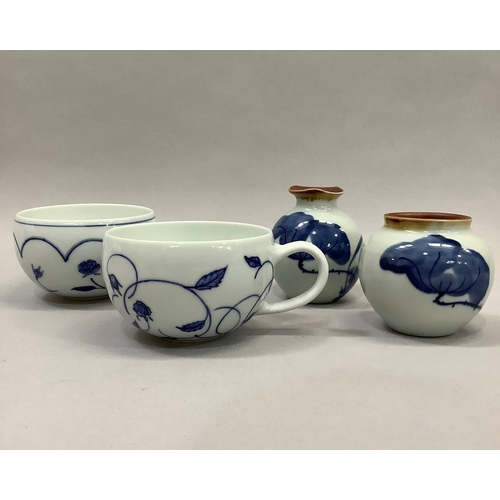 49 - A pair of Jingdezhen blue and white porcelain tea or coffee cups, each with floral decoration, marke... 